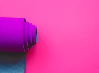 purple yoga mat on a pink background