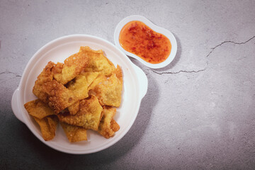 Yellow crispy dumplings on a white plate