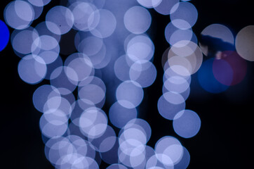 Abstract blue soft blurred bokeh on black background. Shining and blurred circles background. For used wallpaper texture and background with copy space area for a text.