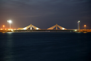 Fototapeta na wymiar Sheikh Salman Causeway bridge, the design with two sail-like structures depict Bahrains traditional pearl diving