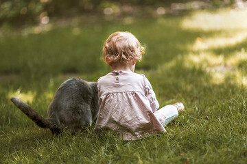 little girl sitting on the grass