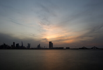 Fototapeta na wymiar Dramatic sky and Bahrain skyline during dusk