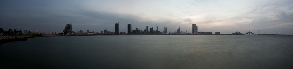 Fototapeta na wymiar A panoramic view of Bahrain skyline at dusk with dramatic cloud