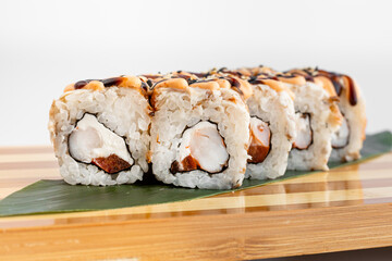 Maki Sushi Rolls set on wooden bamboo board. Japanese traditional Cuisine. White background.