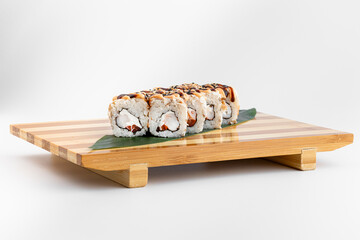 Maki Sushi Rolls set on wooden bamboo board. Japanese traditional Cuisine. White background.