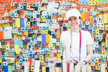 Beautiful asian attractive female pose and smile happiness on colorful ceramic background.