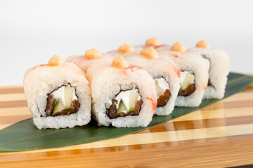 Maki Sushi Rolls set on wooden bamboo board. Japanese traditional Cuisine. White background.