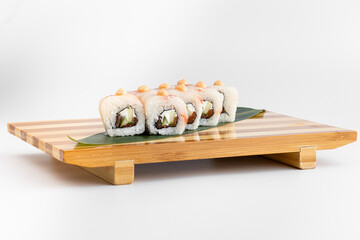 Maki Sushi Rolls set on wooden bamboo board. Japanese traditional Cuisine. White background.
