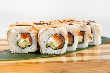 Maki Sushi Rolls set on wooden bamboo board. Japanese traditional Cuisine. White background.