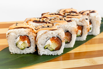 Maki Sushi Rolls set on wooden bamboo board. Japanese traditional Cuisine. White background.