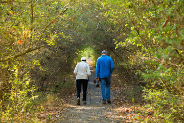 Man and woman  walking on a forest trail near Birmingham, Alabama.