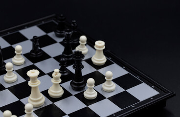 Black king in chess game on chessboard. Black and white figure positioning. Chess figurine order....