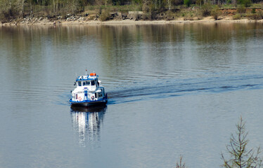 Walking boat unfolds on the river, day, clear weather