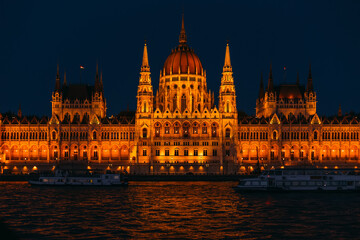 ships on the river in front of the parliament at night Budapest,