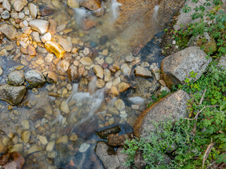 Water from a stream flowing over a rocky bottom