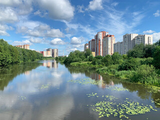 Fototapeta premium Russia, Moscow region, the city of Balashikha. Pekhorka river in summer sunny day and view of Zarechnaya street
