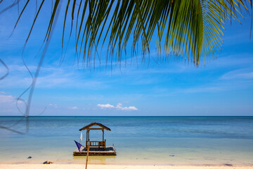 Obraz na płótnie Canvas Floating gazebo on sunny seaside of tropical island. Empty tourist facility on travel ban during COVID-19 pandemic