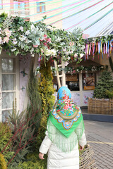 "To you, darlings" Festival in Moscow devoted International Women's Day. 8 march. Holiday decor at Manezhnaya Square in Moscow city. Russian girl in Pavlovo Posad shawl