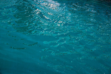 Turquoise blue sea water with ripples. Tropical seaside marine photo background. Clean and transparent seashore