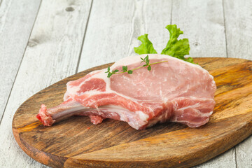 Raw pork bone steak over wooden