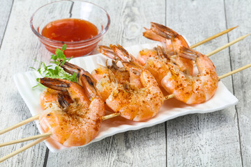 Grilled prawn skewer with sauce