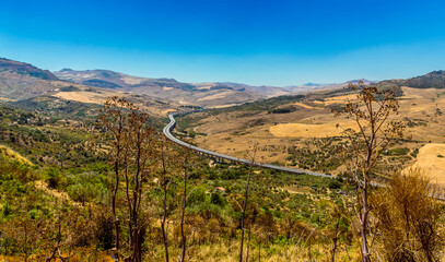 Naklejka premium The Palermo to Catania highway snakes through the Madonie Mountains, Sicily in summer