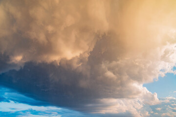 Obraz premium Dark storm clouds before the rain at sunset.
