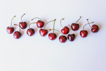 Fototapeta na wymiar Frame of ripe cherry berries on a white background. Copy space. Fresh berries at summer.