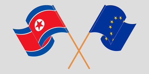 Crossed and waving flags of North Korea and the EU
