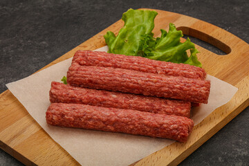 Raw beef sausages with spices