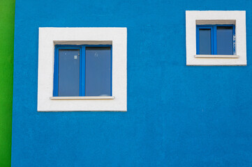 white windows on blue wall