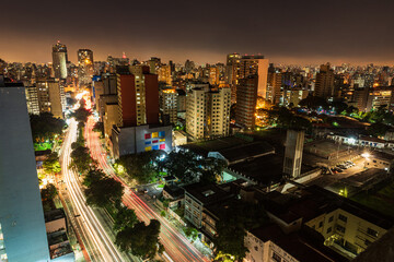 São Paulo city at night. Consolação avenue with urban red and yellow lights. Long exposure shot with car trails. Look from above. Night and dark city.