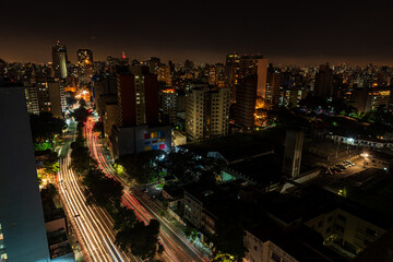 São Paulo city at night. Consolação avenue with urban red and yellow lights. Long exposure shot with car trails. Look from above. Night and dark city.