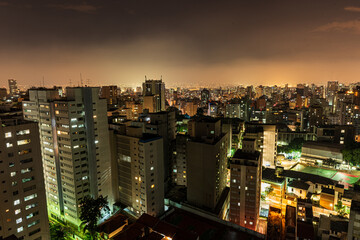 São Paulo city at night. Consolação avenue with urban red and yellow lights. Long exposure shot with car trails. Look from above. Night and dark city.