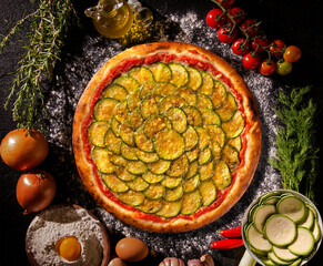 Brazilian pizza with zucchini and cheese. Top view on black concrete background, close up. Traditional Brazilian Pizza