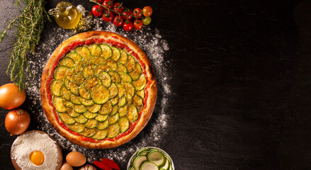Brazilian pizza with zucchini and cheese. Top view on black concrete background, close up. Traditional Brazilian Pizza