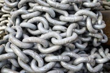 Old industrial chain ropes - the big chains (silver color) close-up
