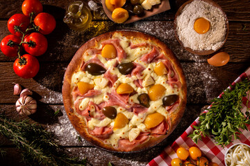 Sweet pizza with peaches, fig and pineapple on wood background. Top view, close up. Traditional Brazilian Pizza