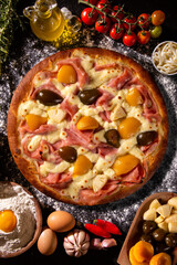 Sweet pizza with peaches, fig and pineapple on black concrete background. Top view, close up. Traditional Brazilian Pizza