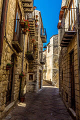 Narrow medieval streets with overhead balconies in Petralia Soprana in the Madonie Mountains, Sicily during summer