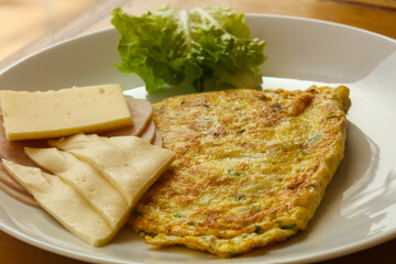 Omelet with cheese and salad