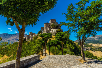An avenue of trees leading to the hilltop village of  Petralia Soprana in the Madonie Mountains,...