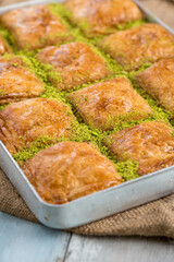 Traditional Turkish dessert baklava in tray on wooden table