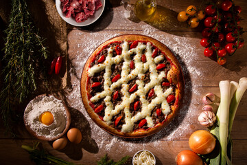 Brazilian pizza with meat, tomato and cream cheese. top view on wood background, close up....