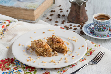 Turkish coffee and Traditional Turkish dessert baklava in plate on wooden table