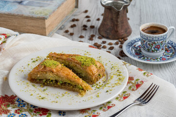 Turkish coffee and Traditional Turkish dessert baklava in plate on wooden table