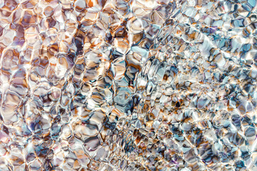 Texture of pebbles through clear glass sea water. Top view, summer background, vacation, summer holidays, travel, sustainability, ecology, Earth Day concept.