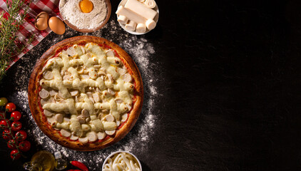 palm heart and cream cheese Pizza. Top view on black concrete background, close up. Traditional Brazilian Pizza