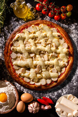 palm heart and cream cheese Pizza. Top view on black concrete background, close up. Traditional Brazilian Pizza