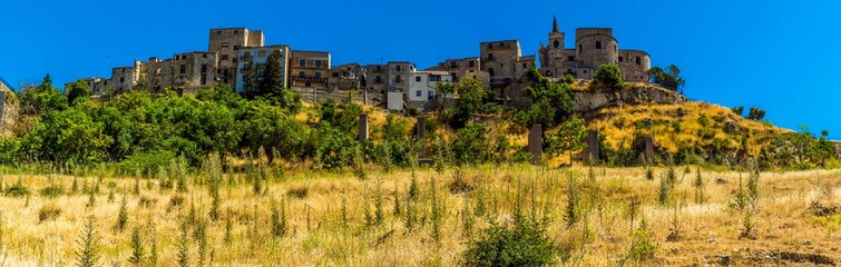 Fototapeta na wymiar The hilltop village of Petralia Soprana against the backdrop of a bright blue sky in the Madonie Mountains, Sicily during summer
